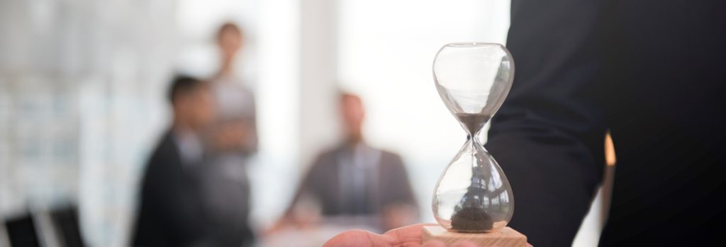 3 businessman holding hour glass signifies importance being time